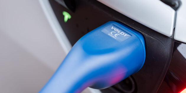 Close-up of a blue Voldt Type 2 EV charging cable connector in a white car's charging port